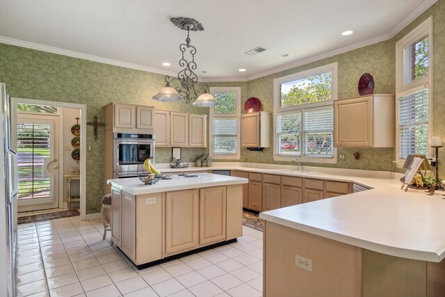 kitchen with plenty of natural light, a center island, an inviting chandelier, and stainless steel oven