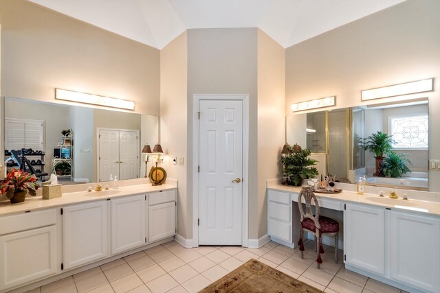 bathroom featuring vanity, high vaulted ceiling, and tile patterned floors