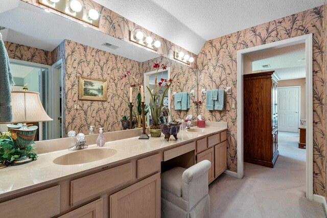 bathroom with vanity and a textured ceiling