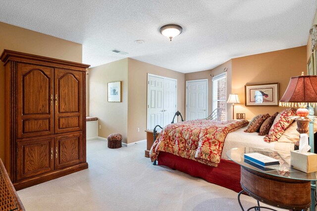 carpeted bedroom with a textured ceiling