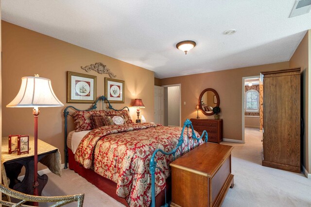 carpeted bedroom with a textured ceiling