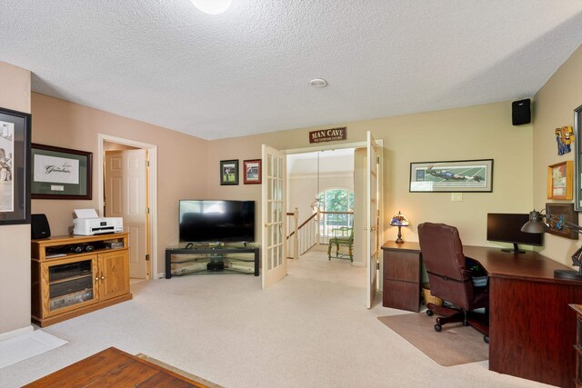 carpeted office space with a textured ceiling