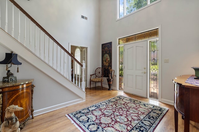 foyer featuring a high ceiling and light hardwood / wood-style floors