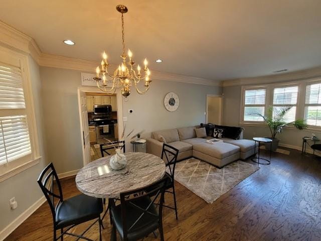 dining space featuring ornamental molding, dark wood-type flooring, and a notable chandelier