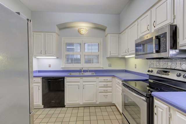 kitchen with light tile patterned floors, white cabinetry, stainless steel appliances, and sink