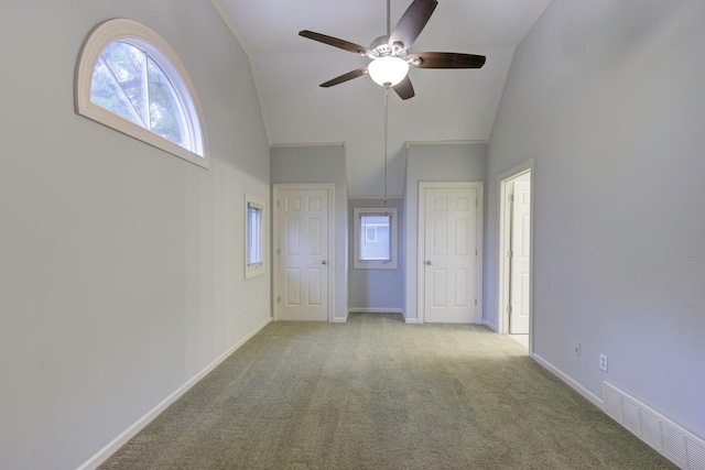 unfurnished bedroom featuring ceiling fan, light carpet, and high vaulted ceiling