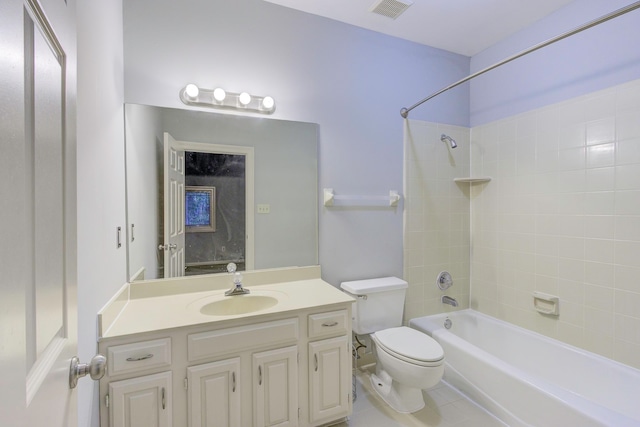 full bathroom featuring tile patterned flooring, toilet, tiled shower / bath combo, and vanity