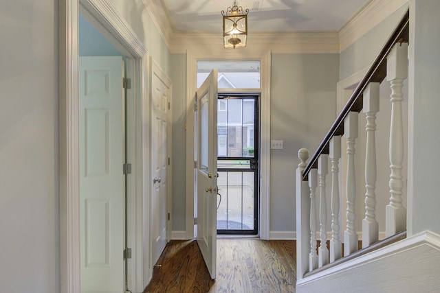 entryway with wood-type flooring and crown molding