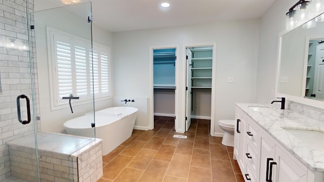 full bathroom featuring vanity, toilet, tile patterned floors, and shower with separate bathtub