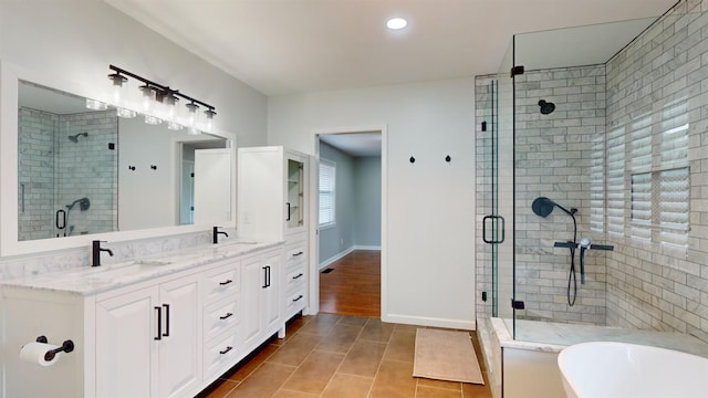 bathroom featuring vanity, tile patterned floors, and shower with separate bathtub