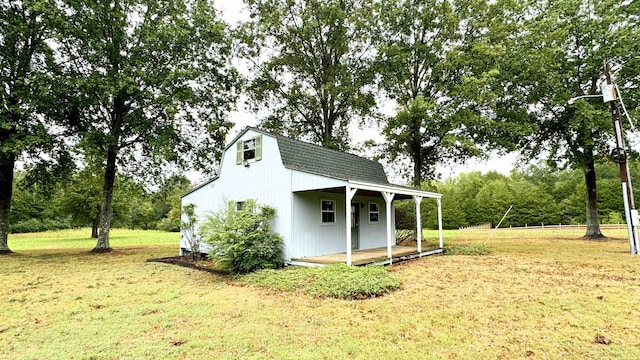 view of outbuilding with a yard