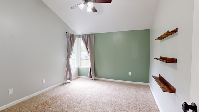 carpeted spare room with lofted ceiling and ceiling fan