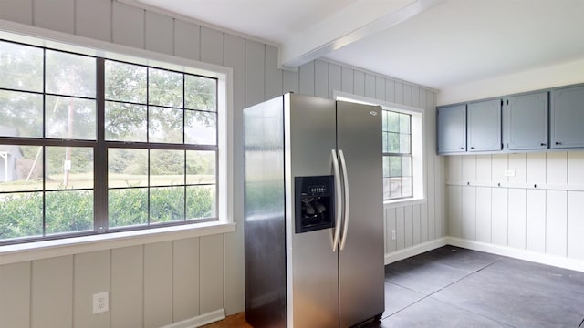 kitchen featuring a healthy amount of sunlight, gray cabinetry, beamed ceiling, and stainless steel refrigerator with ice dispenser