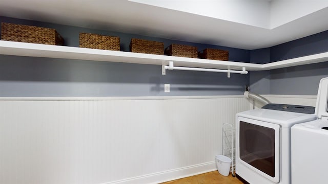 clothes washing area with washer and clothes dryer