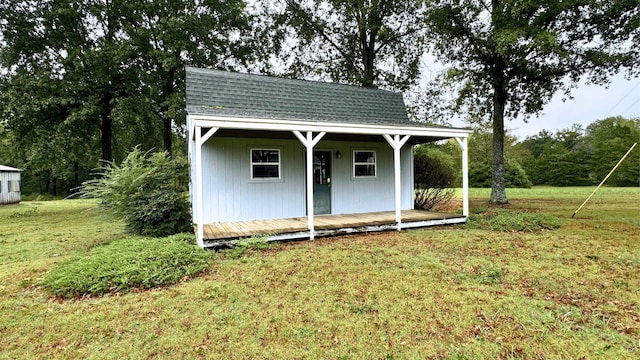 view of outbuilding with a yard