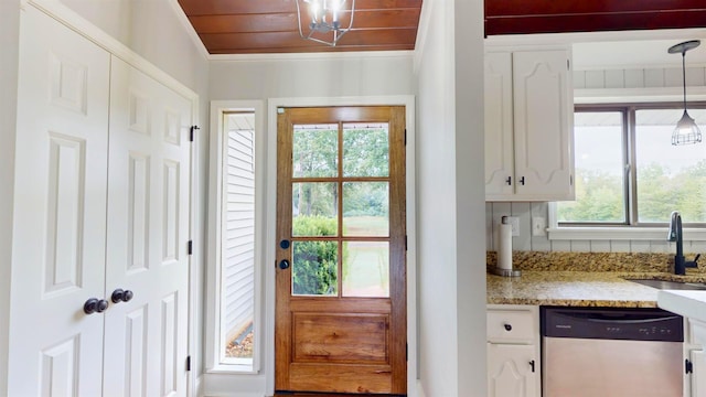 doorway to outside featuring ornamental molding, plenty of natural light, and sink