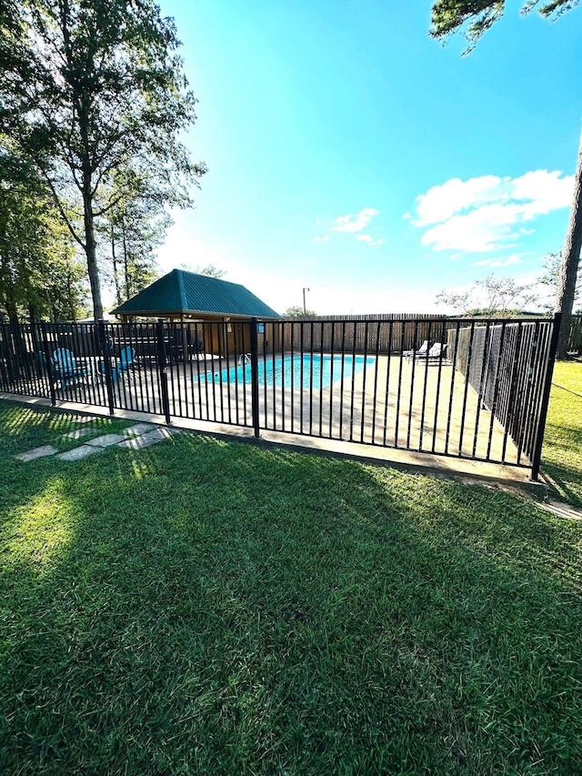 view of swimming pool featuring a lawn