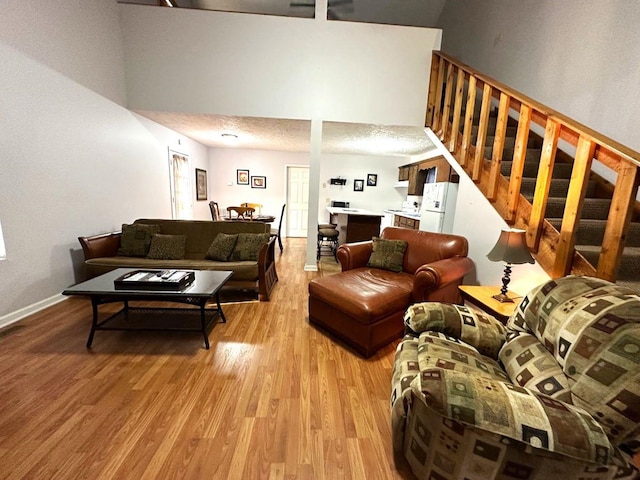 living room featuring a textured ceiling and light hardwood / wood-style floors