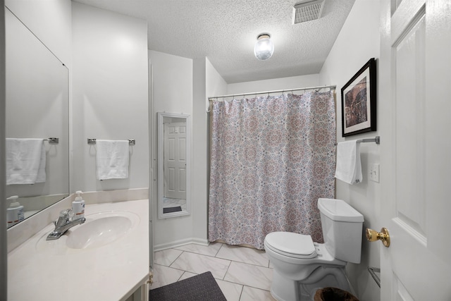 bathroom featuring toilet, tile patterned flooring, vanity, a textured ceiling, and curtained shower