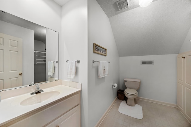 bathroom featuring vaulted ceiling, toilet, vanity, and a textured ceiling