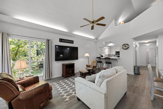 180 Vantage Pt, Counce, TN 38326 - living room featuring wood finished floors, a ceiling fan, baseboards, and high vaulted ceiling