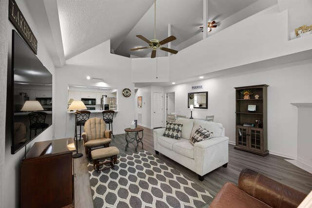180 Vantage Pt, Counce, TN 38326 - living room with baseboards, high vaulted ceiling, a ceiling fan, and wood finished floors