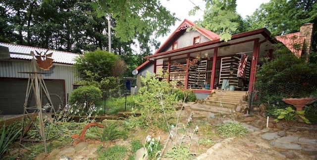 rear view of property featuring a garage