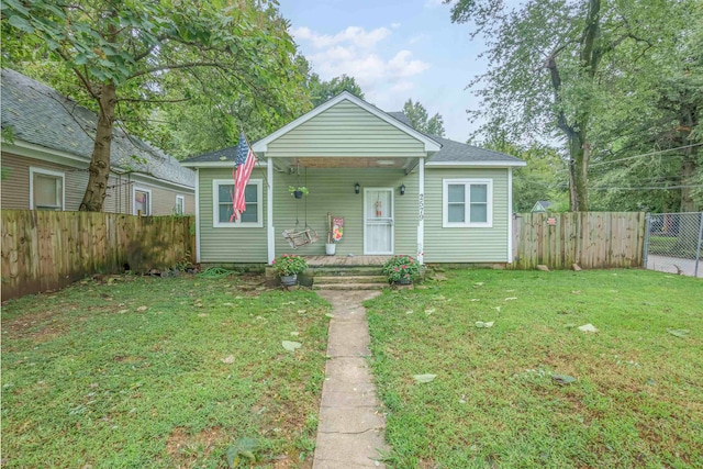 bungalow-style home featuring a front lawn