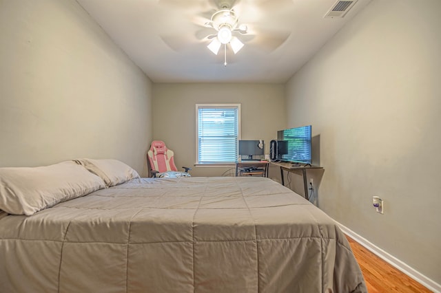 bedroom with ceiling fan and hardwood / wood-style floors