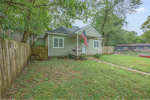 bungalow-style house featuring a front lawn