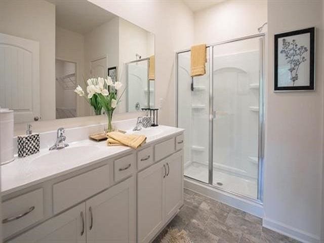 bathroom featuring vanity and walk in shower