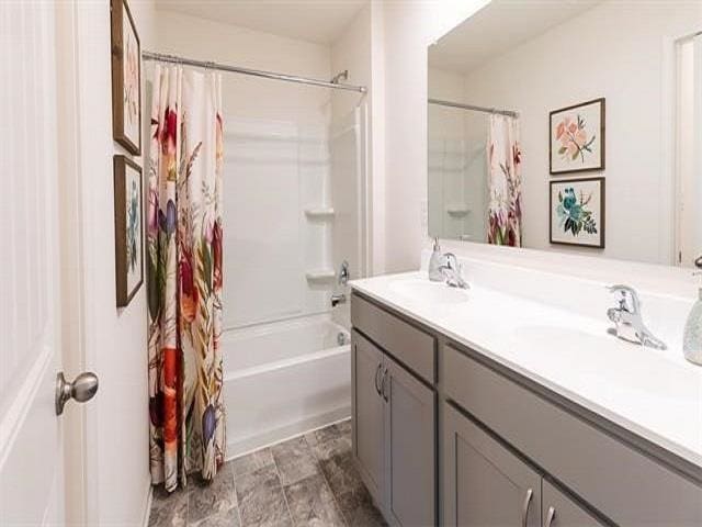 bathroom featuring vanity and shower / tub combo