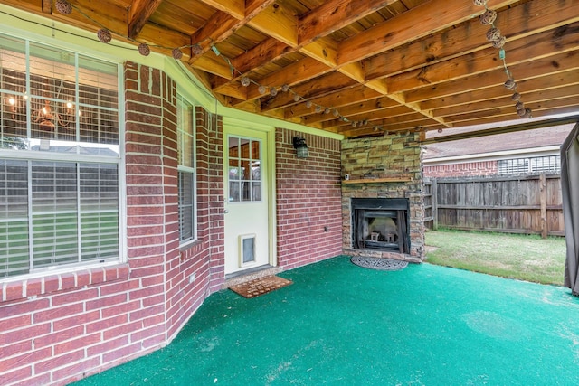 view of patio featuring an outdoor stone fireplace