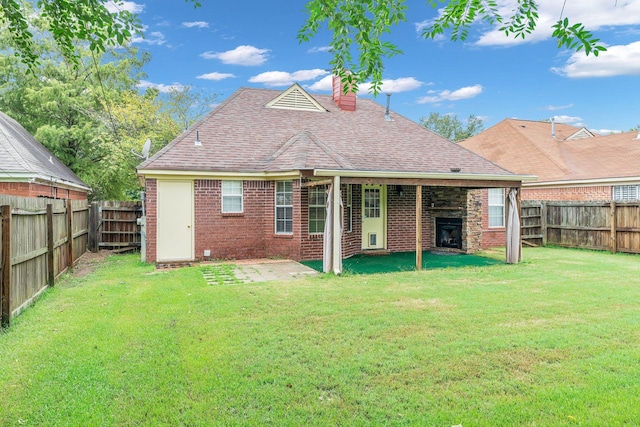 back of property with a patio and a yard