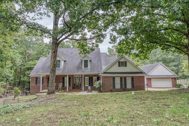 new england style home with a garage and a front yard