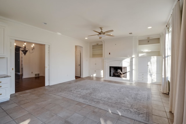 unfurnished living room featuring light hardwood / wood-style floors, ceiling fan with notable chandelier, built in shelves, and crown molding