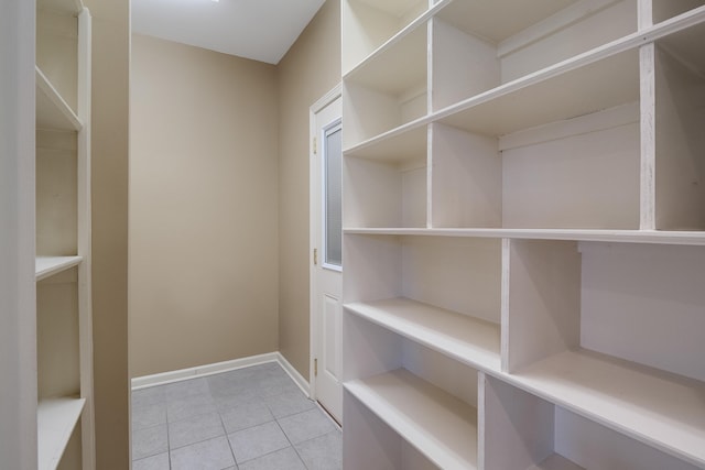 walk in closet featuring light tile patterned flooring