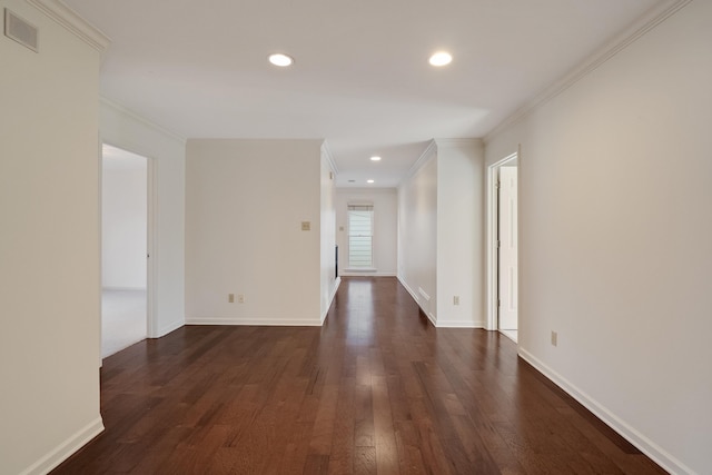 spare room with ornamental molding and dark hardwood / wood-style flooring