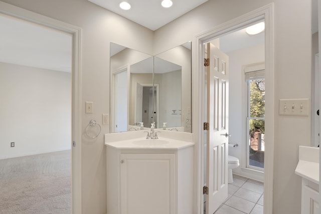 bathroom featuring vanity, toilet, and tile patterned floors