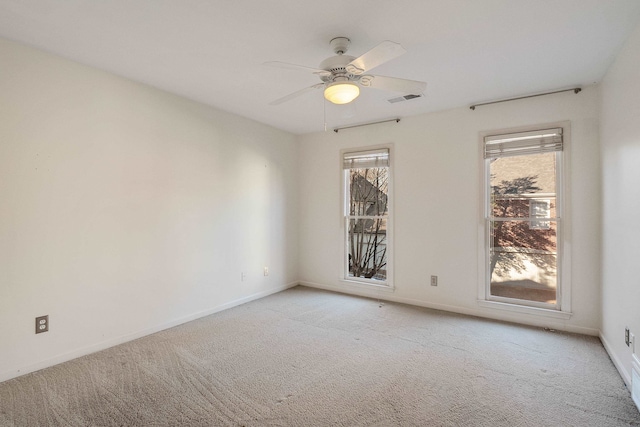 unfurnished room featuring ceiling fan and light colored carpet