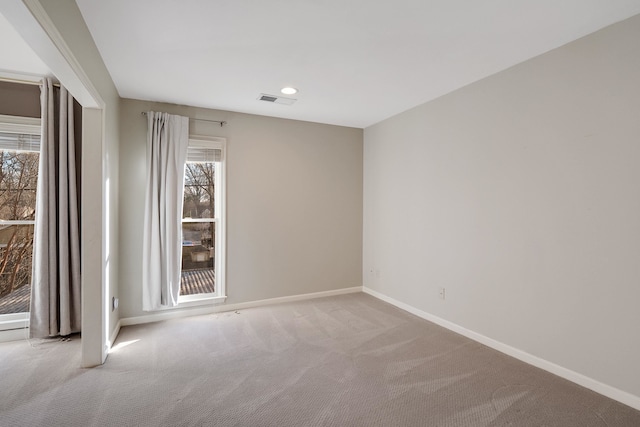 unfurnished room with light carpet