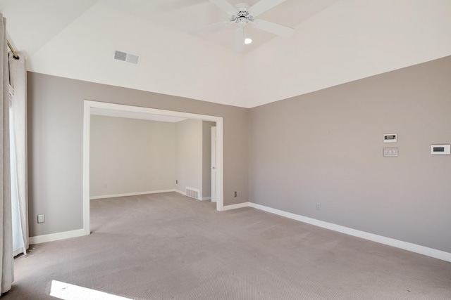 unfurnished room featuring vaulted ceiling, ceiling fan, and light colored carpet