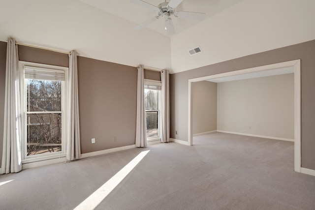 unfurnished room featuring high vaulted ceiling, ceiling fan, and light colored carpet