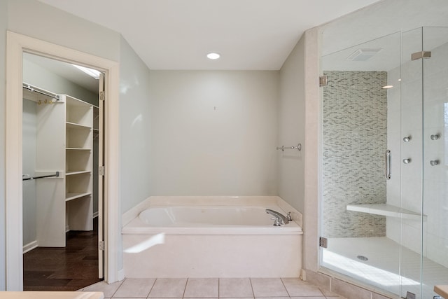 bathroom with plus walk in shower and tile patterned flooring