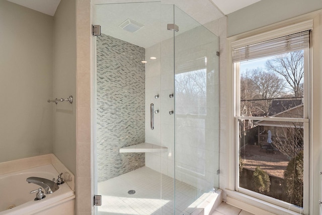 bathroom featuring independent shower and bath