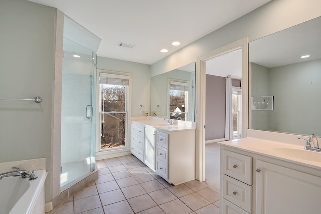 bathroom featuring independent shower and bath, tile patterned flooring, and vanity