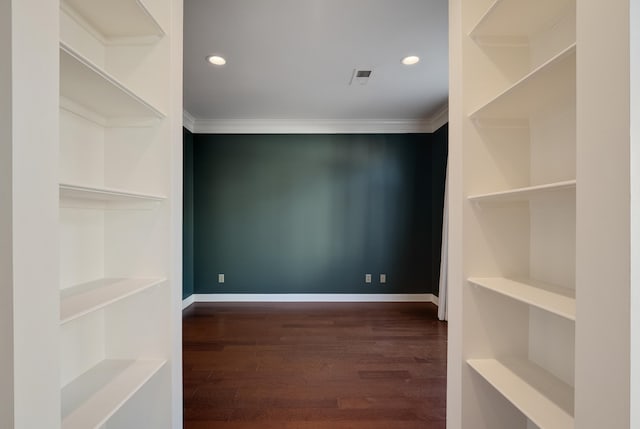 spacious closet with dark hardwood / wood-style flooring