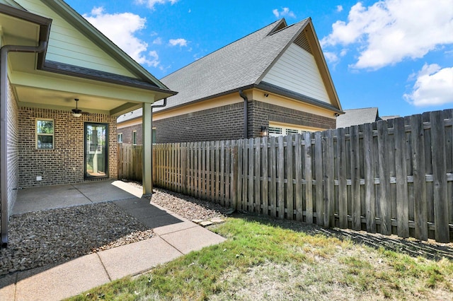 view of yard featuring ceiling fan and a patio area