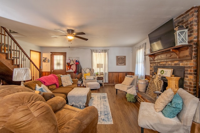 living room featuring a fireplace, hardwood / wood-style floors, ceiling fan, and plenty of natural light