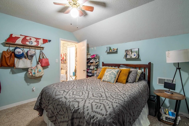 bedroom with ceiling fan, a textured ceiling, lofted ceiling, and carpet flooring